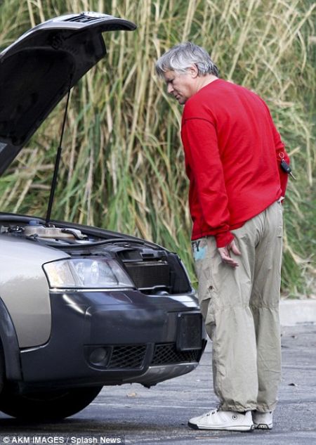 Richard Dean Anderson looks at his broken Audi.